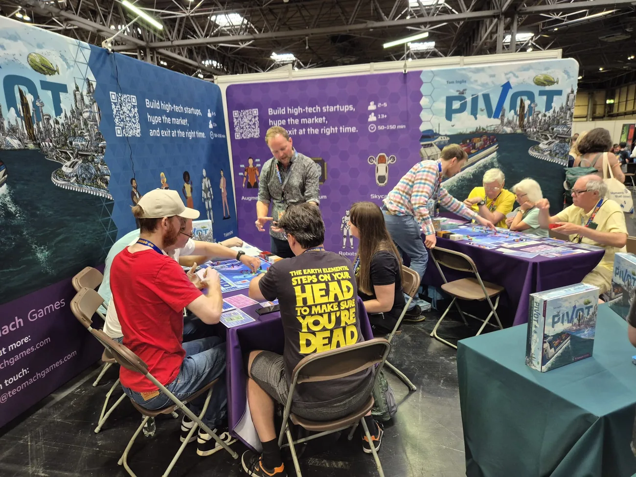 Players around the Pivot table from a different angle at UK Games Expo