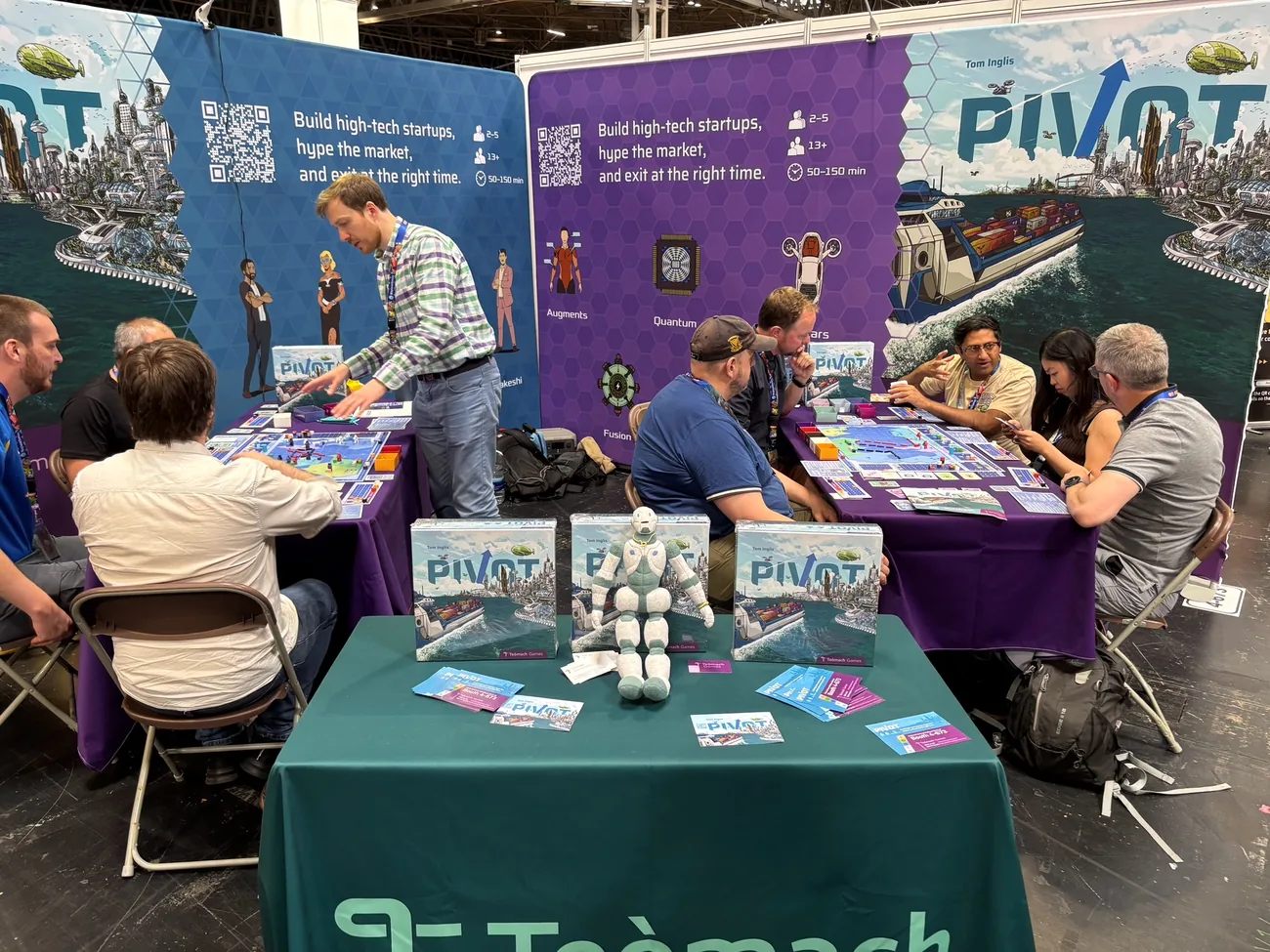 The Teòmach Games stand at UK Games Expo, two full tables of players learning Pivot